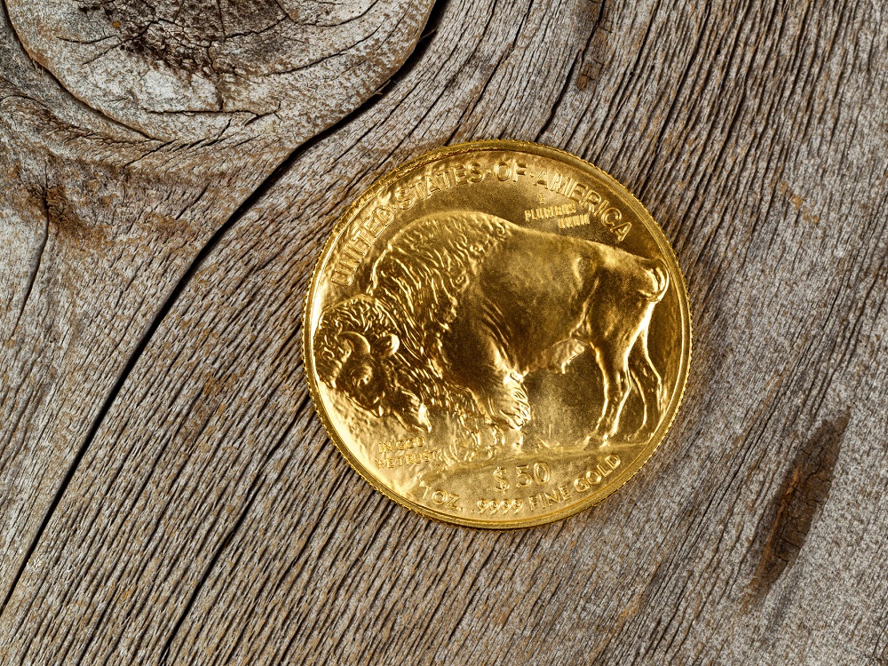 gold buffalo coin on a wooden table